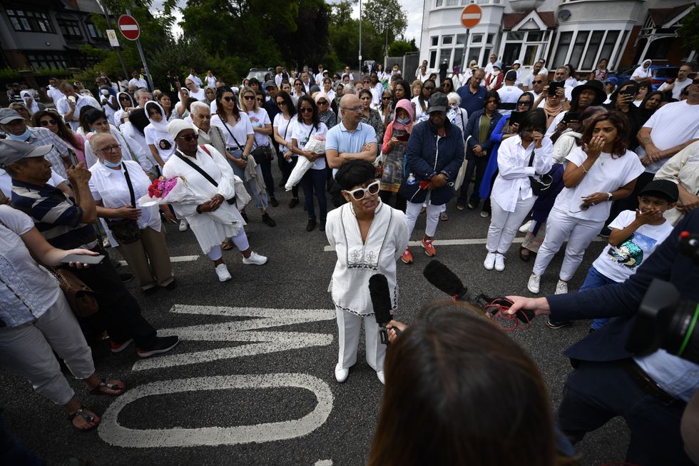 Anjum Mouj speaks to the media at the vigil.