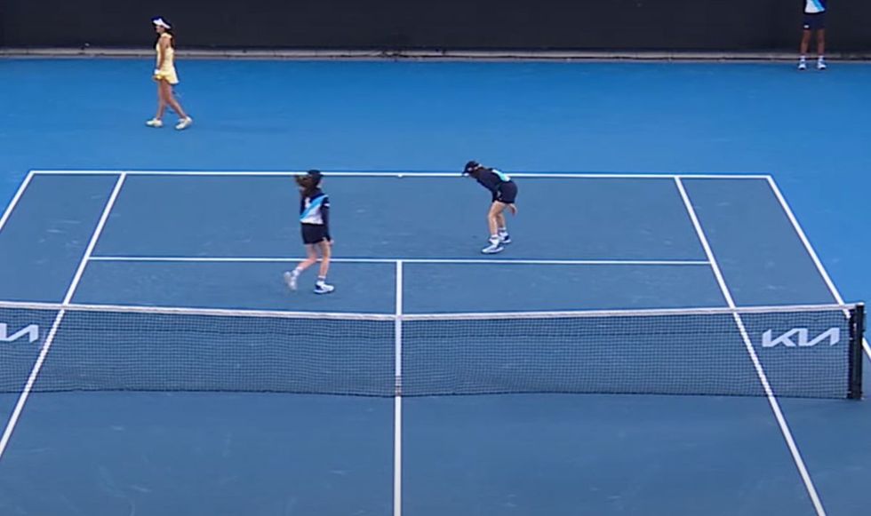 Another ball girl came over the help