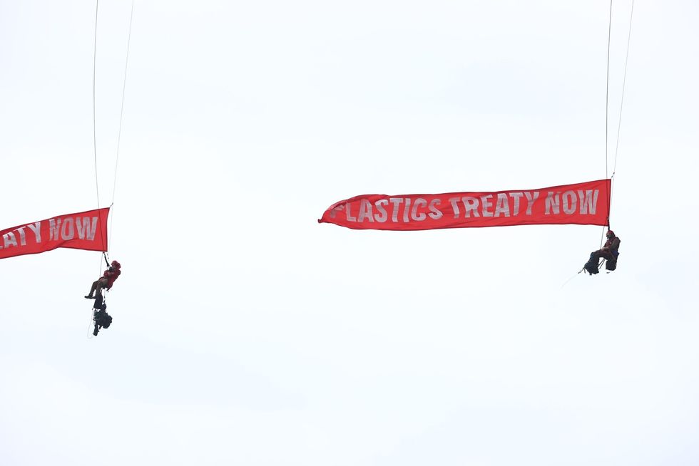 Another image of Greenpeace activists holding red banners
