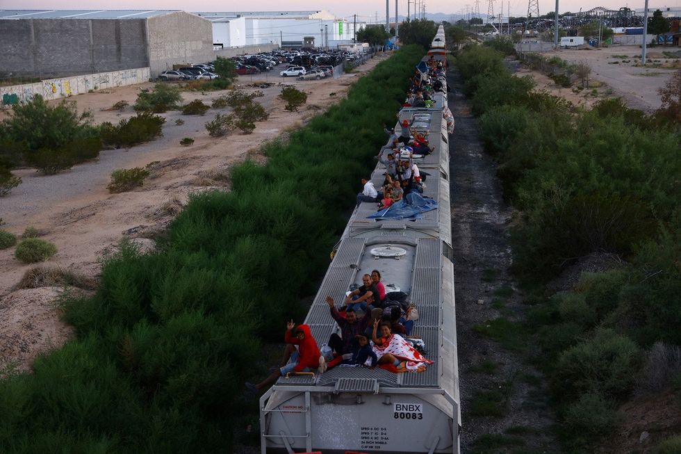Another image of migrants travelling aboard a train