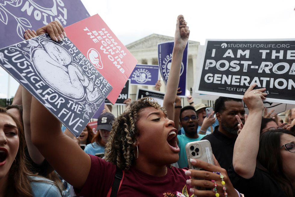 Anti-abortion demonstrators celebrate outside the United States Supreme Court as the court rules in the Dobbs v Women\u2019s Health Organization abortion case, overturning the landmark Roe v Wade abortion decision in Washington, U.S., June 24, 2022. REUTERS/Evelyn Hockstein