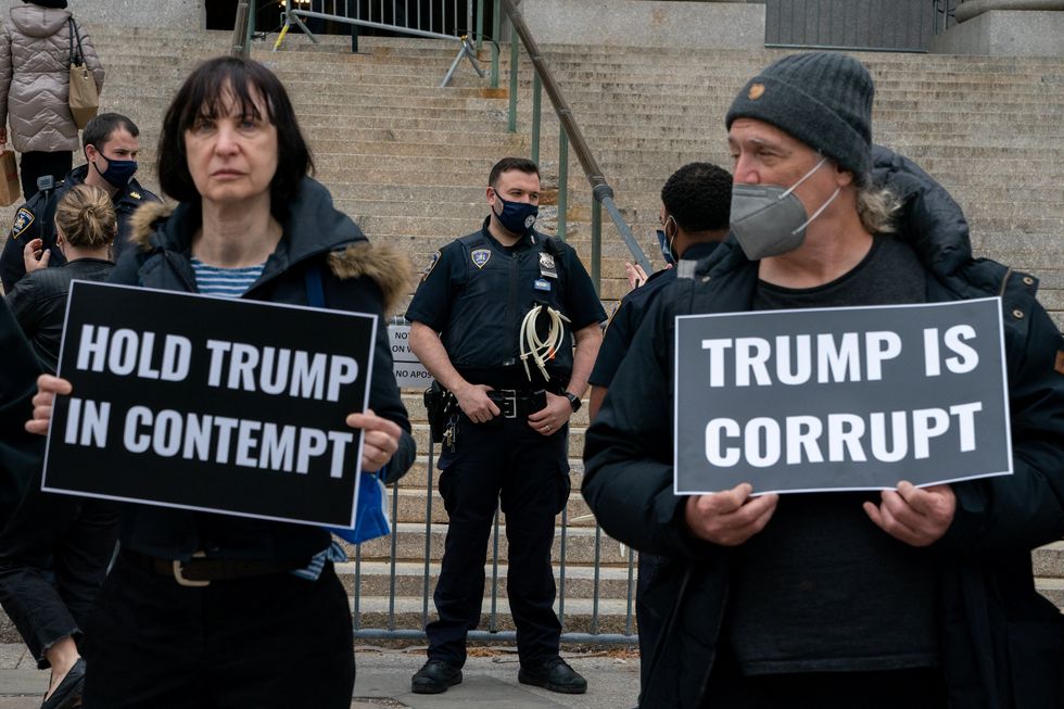 Anti-Trump demonstrators gather outside of the New York County Supreme Court in New York City, U.S., April 25, 2022. REUTERS/David 'Dee' Delgado