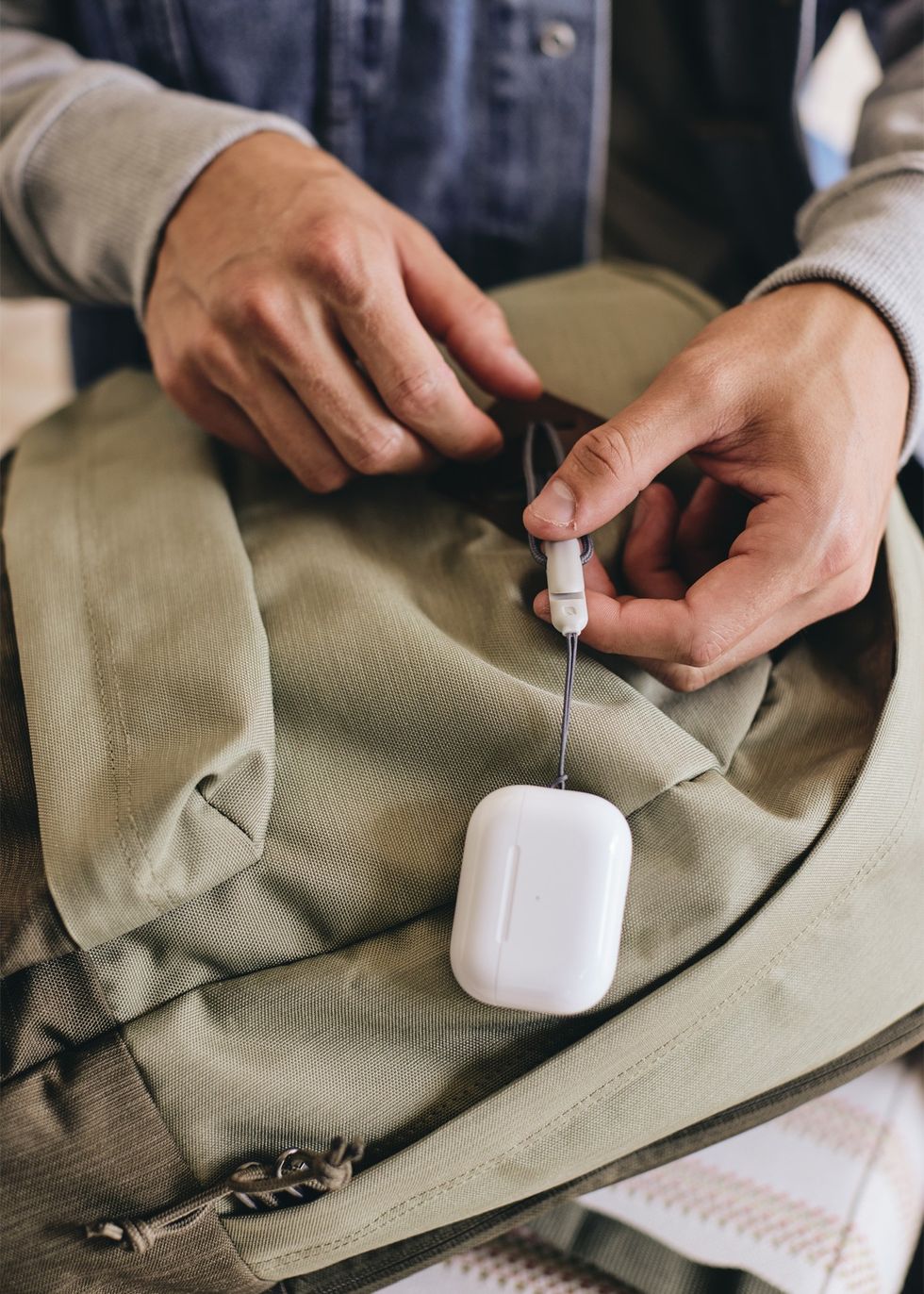 apple airpods pro with lanyard attached to someones bag