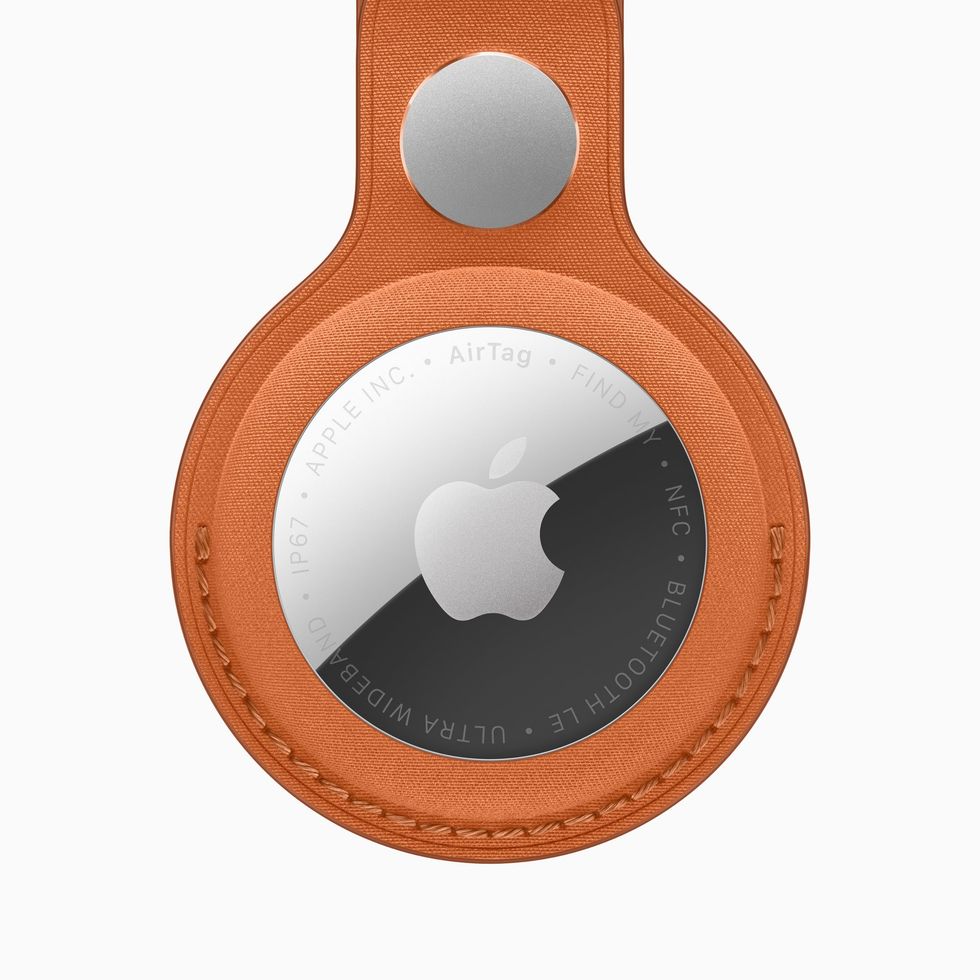 Apple AirTag 2 pictured in the new FineWoven Key Ring in Fox Orange