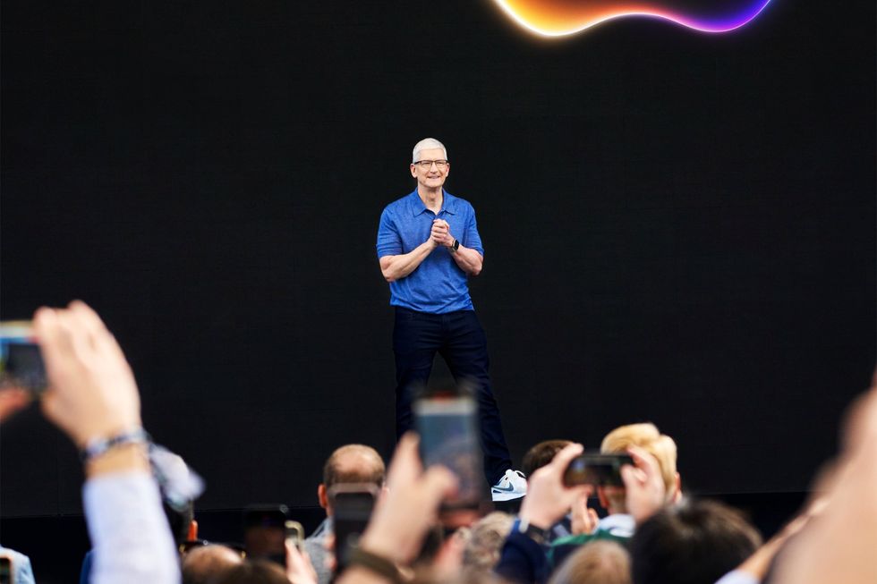 Apple CEO Tim Cook speaking on-stage at WWDC 