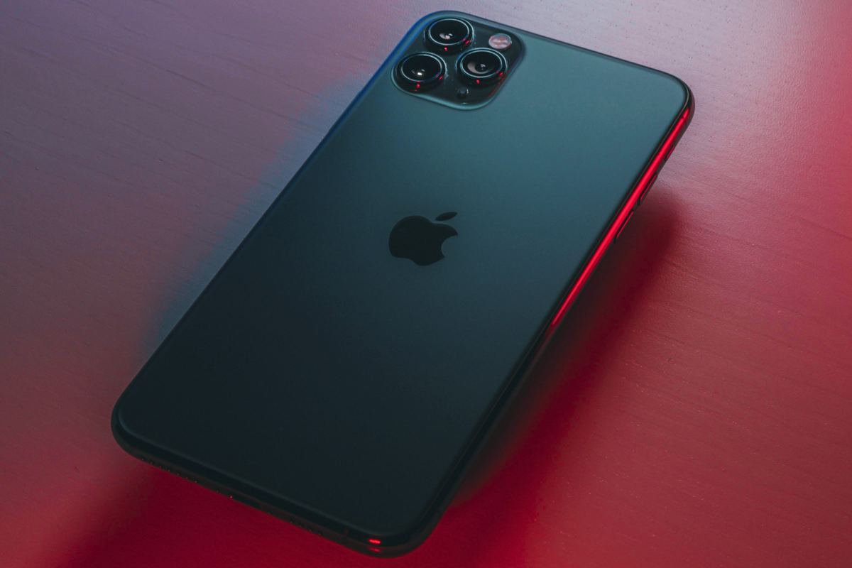 apple iphone 13 pro pictured facing down on a red table 