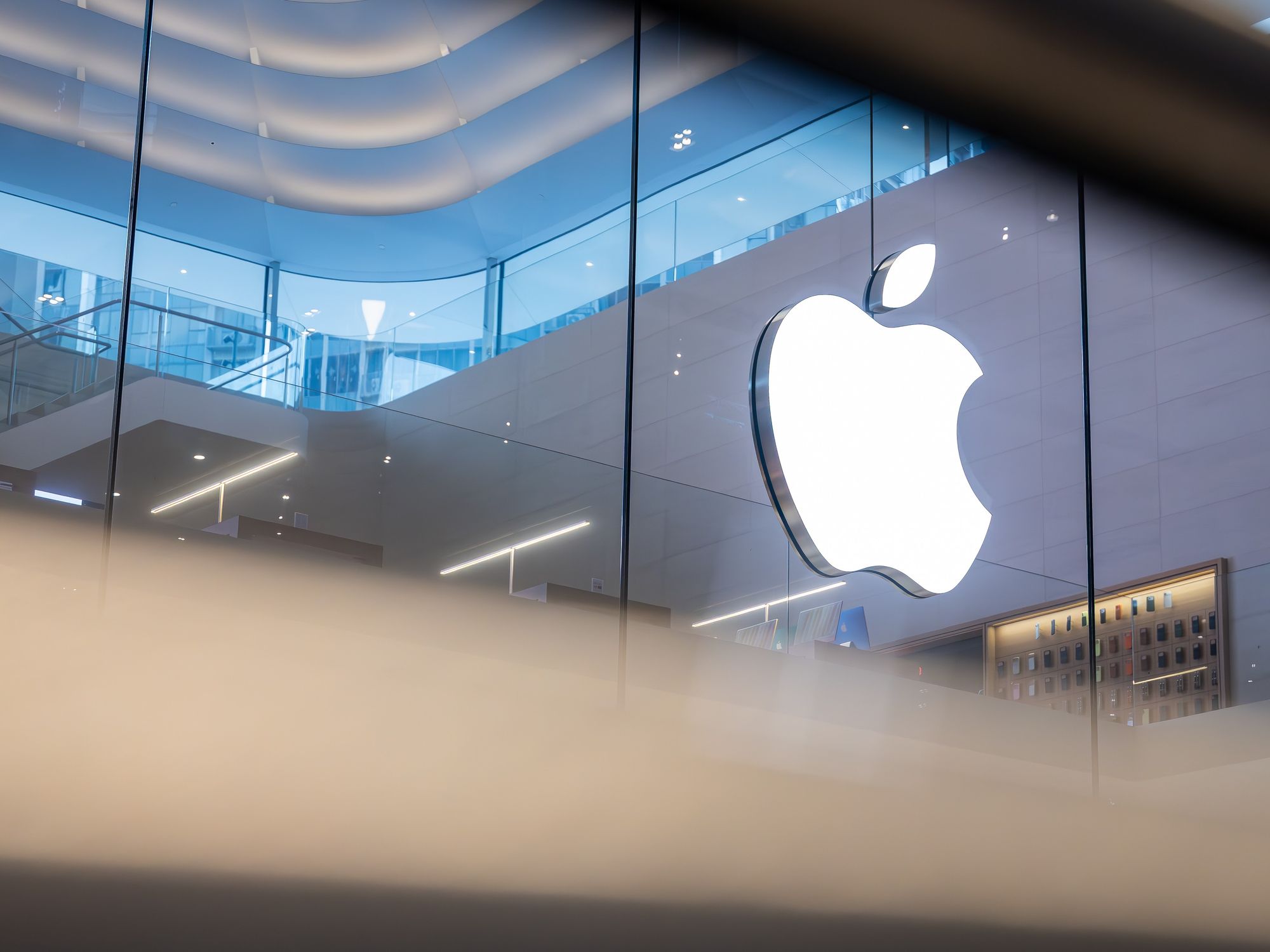 apple logo pictured inside an Apple Store