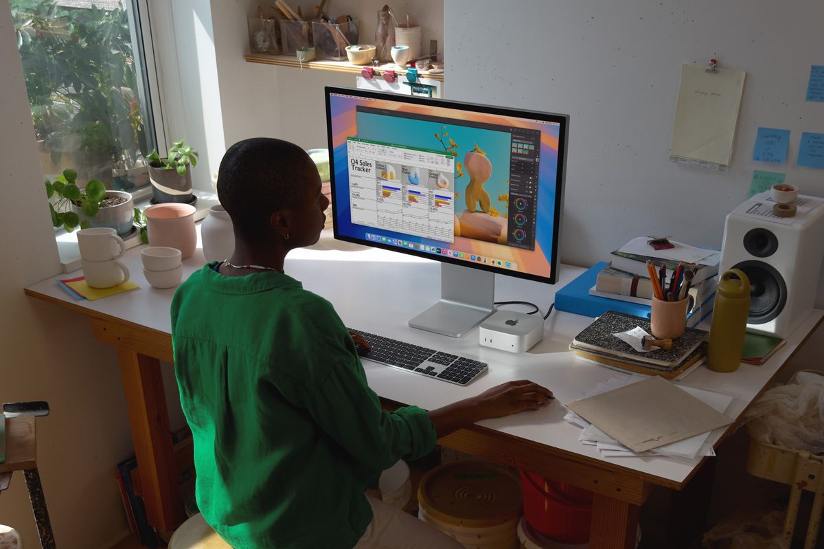 apple mac mini pictured on a desk with a monitor