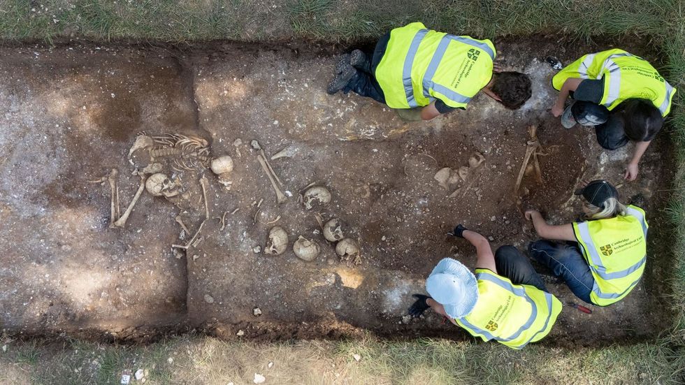 Archaeologists digging the burial pit