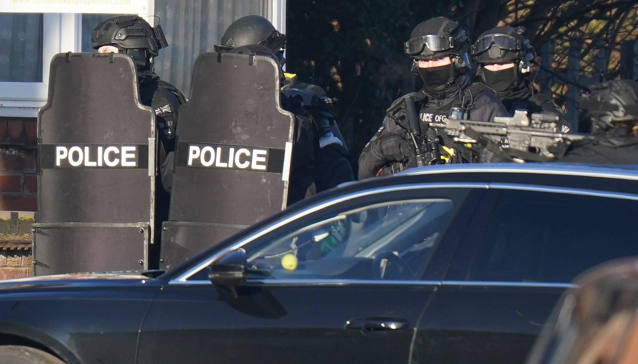 Armed police officers outside a property in Earlsdon Avenue North, Coventry, where police remain in a stand-off with a man. Officers from West Midlands Police were called to the property on Sunday to carry out a welfare check on a man and child, who are both believed to still be inside the property. Picture date: Wednesday January 12, 2022.