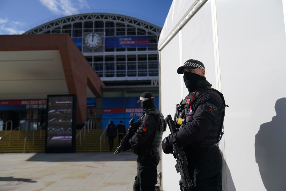 Armed police officers outside the Conservative Party Conference at Manchester Central in Manchester. Picture date: Sunday October 3, 2021.