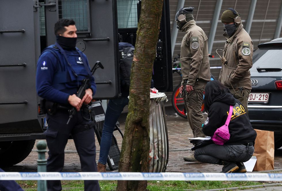 Armed security personnel secure the area at the Clemenceau metro station after the shooting