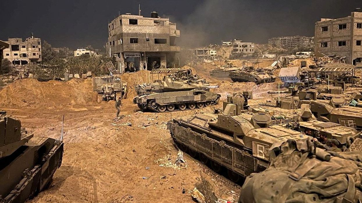 Armoured vehicles of the Israel Defense Forces (IDF) are seen during their ground operations at a location given as Gaza