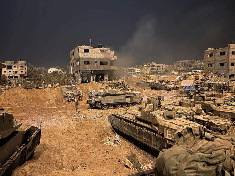 Armoured vehicles of the Israel Defense Forces (IDF) are seen during their ground operations at a location given as Gaza