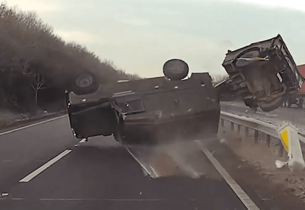 Army Land Rover spinning in the road