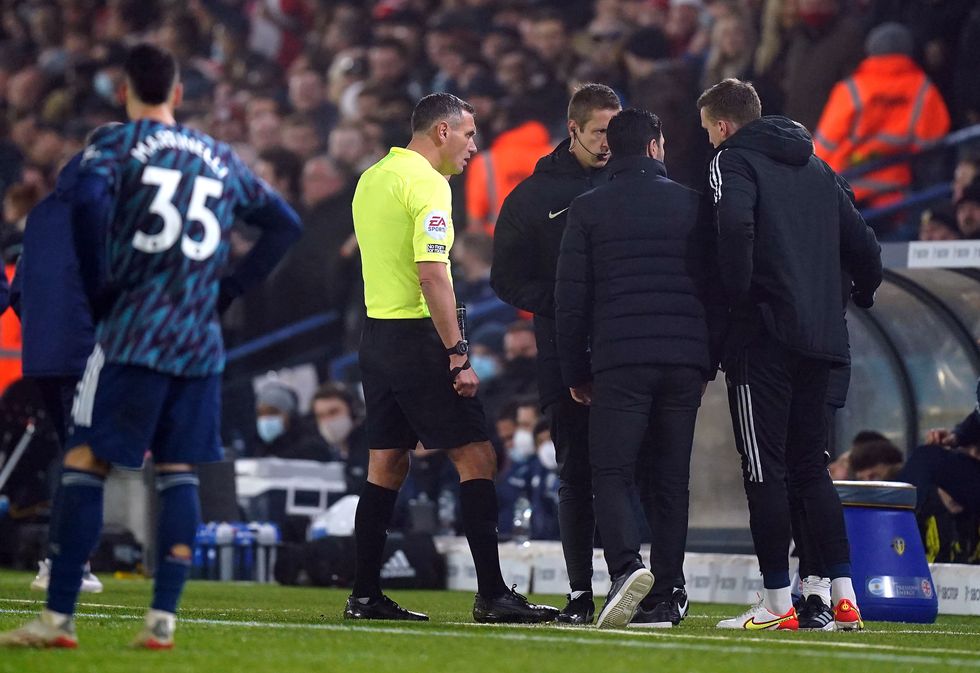 Arsenal manager Mikel Arteta (centre) speaks with referee Andre Marriner (left) and fourth official John Brooks after alleged racist abuse was aimed at the Arsenal bench during the Premier League match at Elland Road.