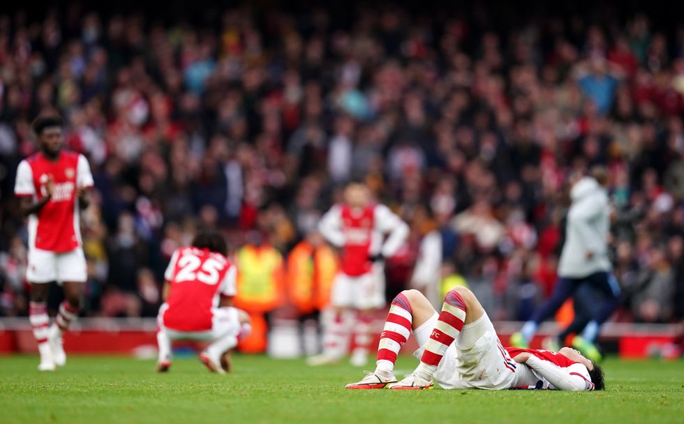 Arsenal's Takehiro Tomiyasu (right) lies dejected after the game.