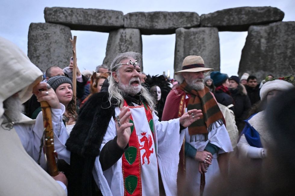 Arthur Pendragon, who ordained Angela Howard, leads incantations as revellers celebrate the pagan festival of 'Winter Solstice' at Stonehenge