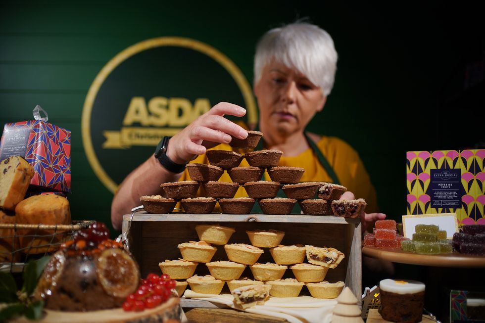Asda employee with mince pies at Christmas preview