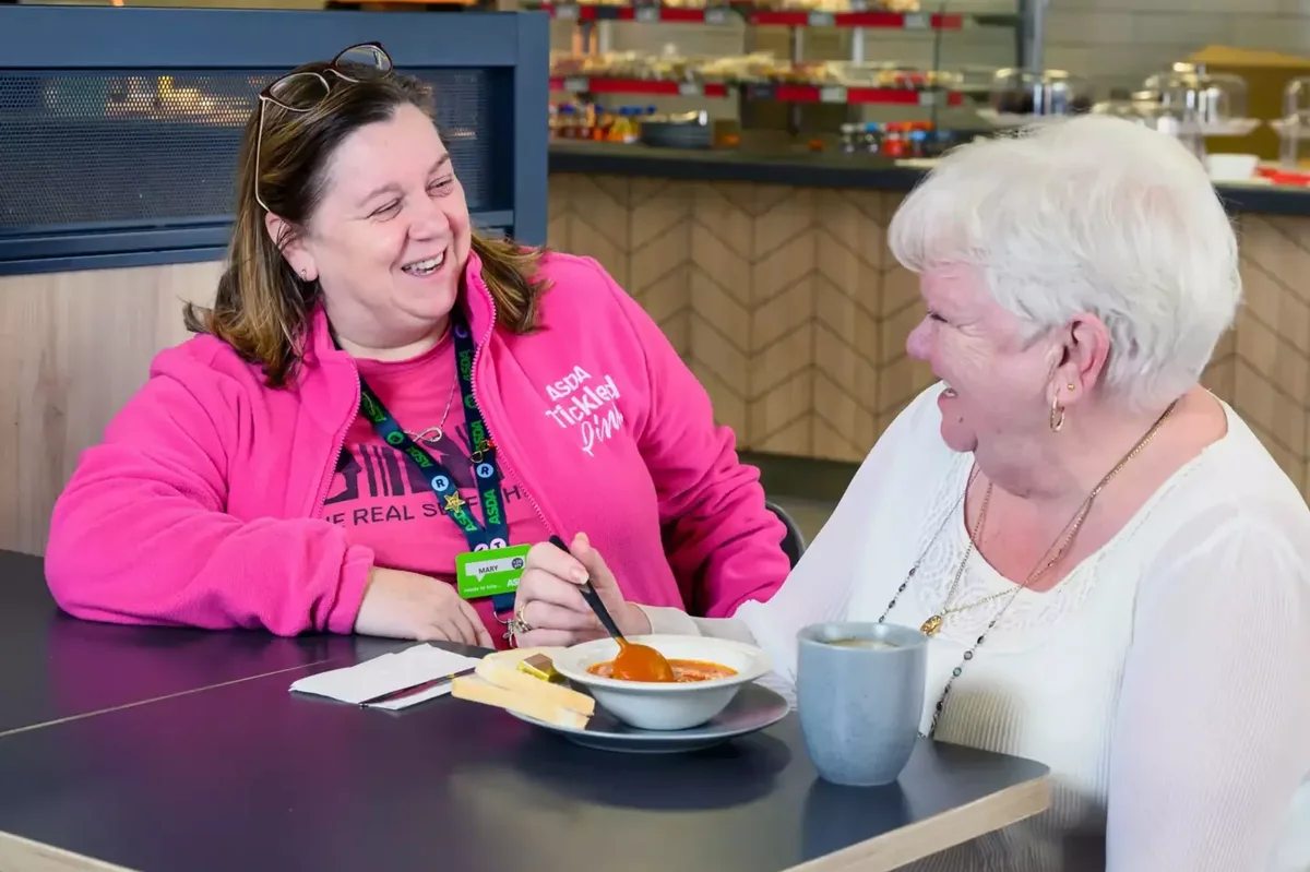 Asda worker enjoying a meal with over 60s shopper