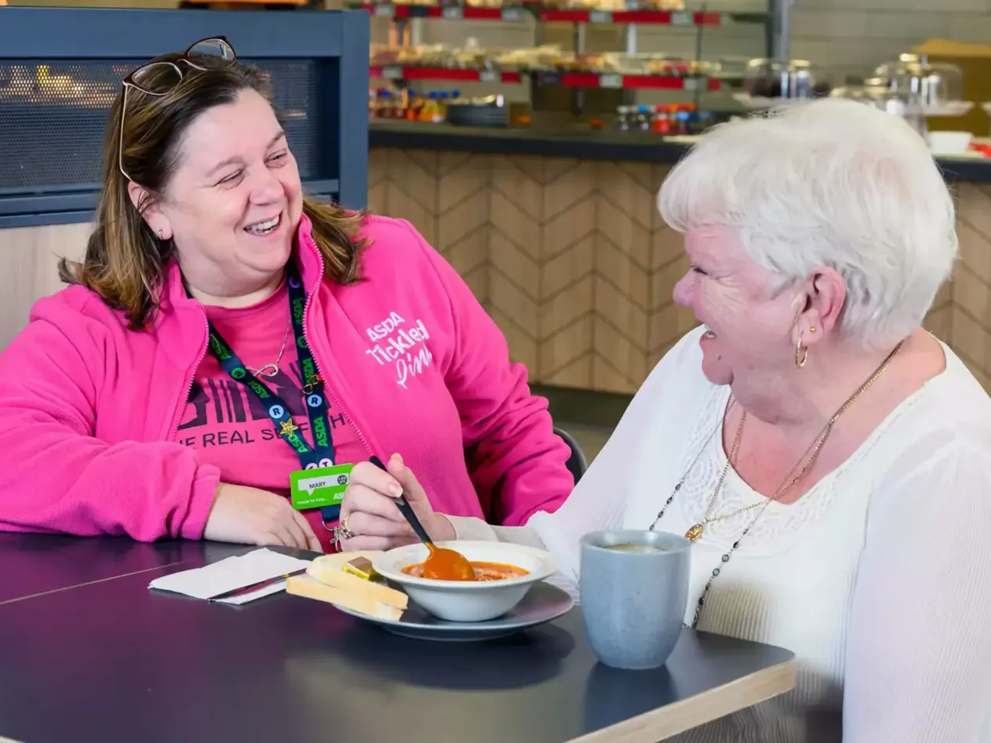 Asda worker enjoying a meal with over 60s shopper