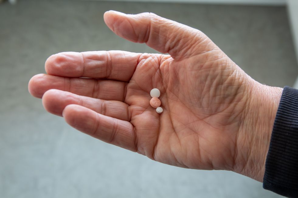 aspirin pills in hand