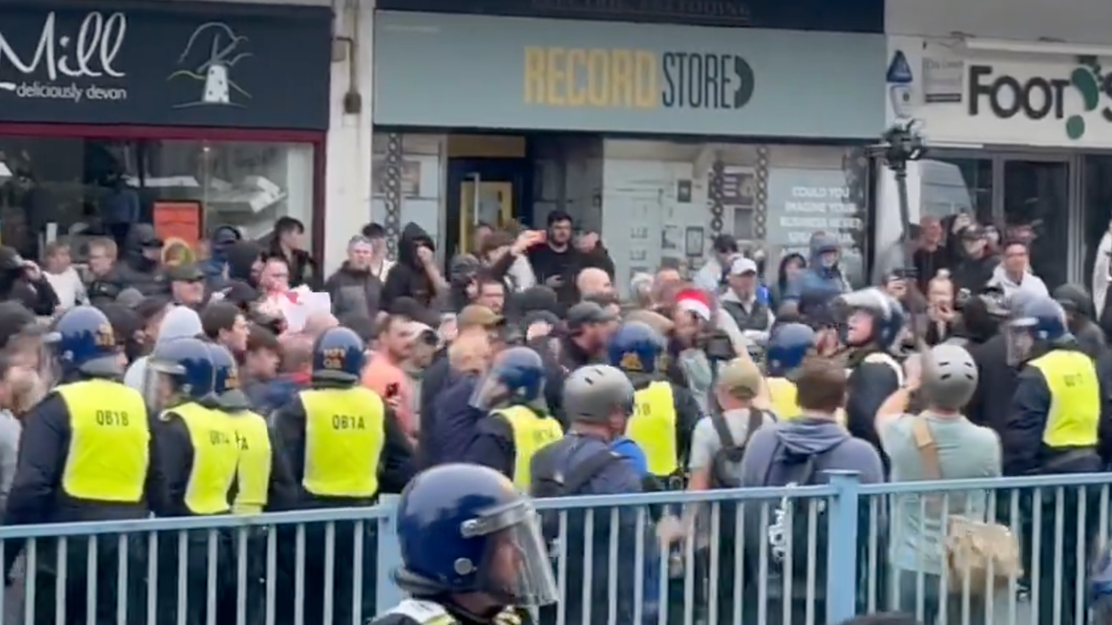 Riot police with dogs clash with protesters as violence emerges in Plymouth