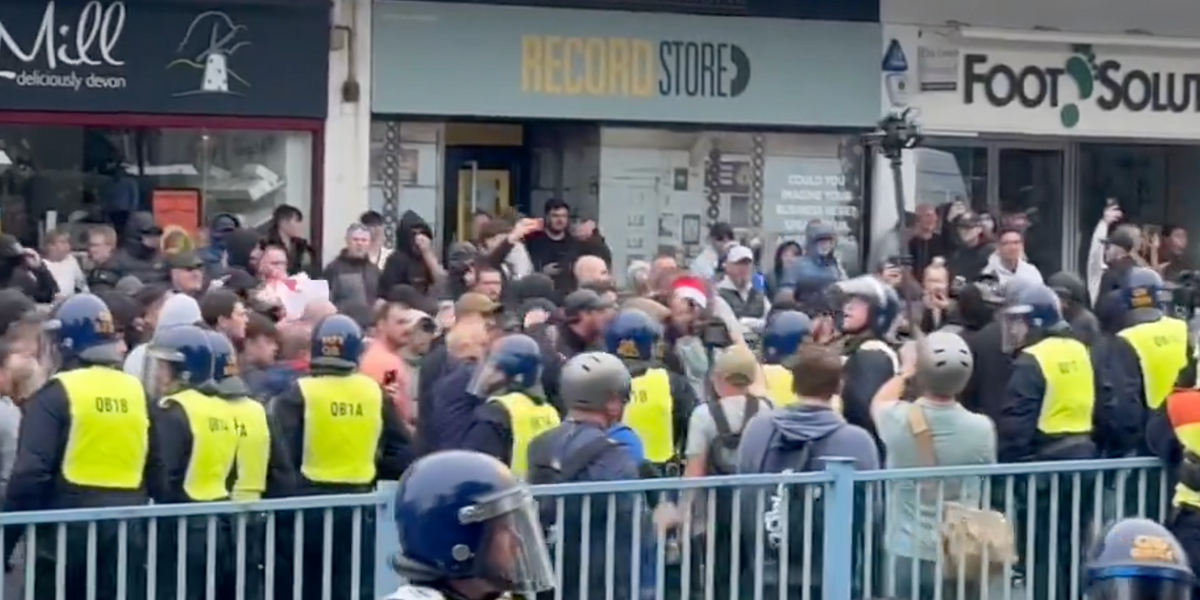 NextImg:Riot police with dogs clash with protesters as violence emerges in Plymouth
