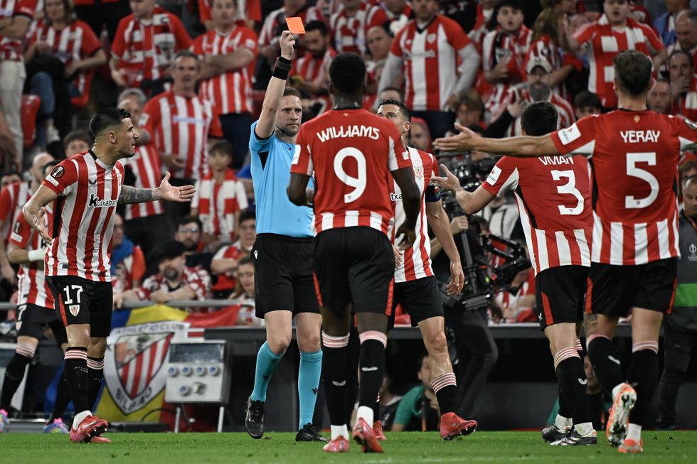 Athletic Bilbao players protest a red card.