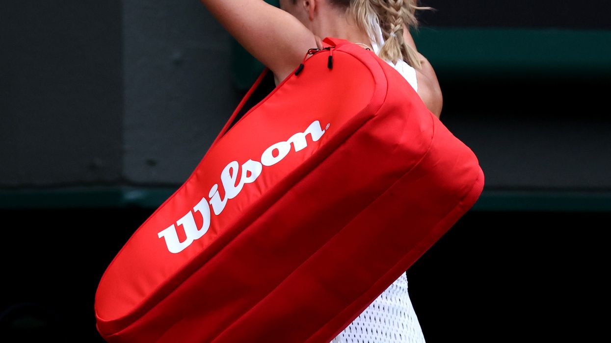 Azarenka with her fists clenched in the air as she leaves the court
