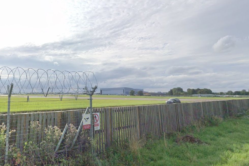 Barbed wire on top of the fence stops in front of the runway