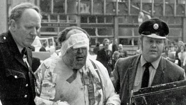 Barrister James Crespi being led away, wounded and bandaged, after being hurt by an IRA bomb outside the Old Bailey in 1973