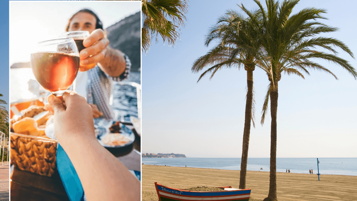 Beach at Estepona on Spain's Costa del Sol / people cheersing drinks on holiday
