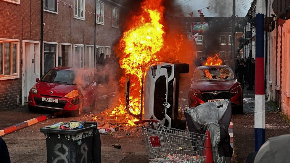 Belfast was left burning after thousands protested Monday's knife attack