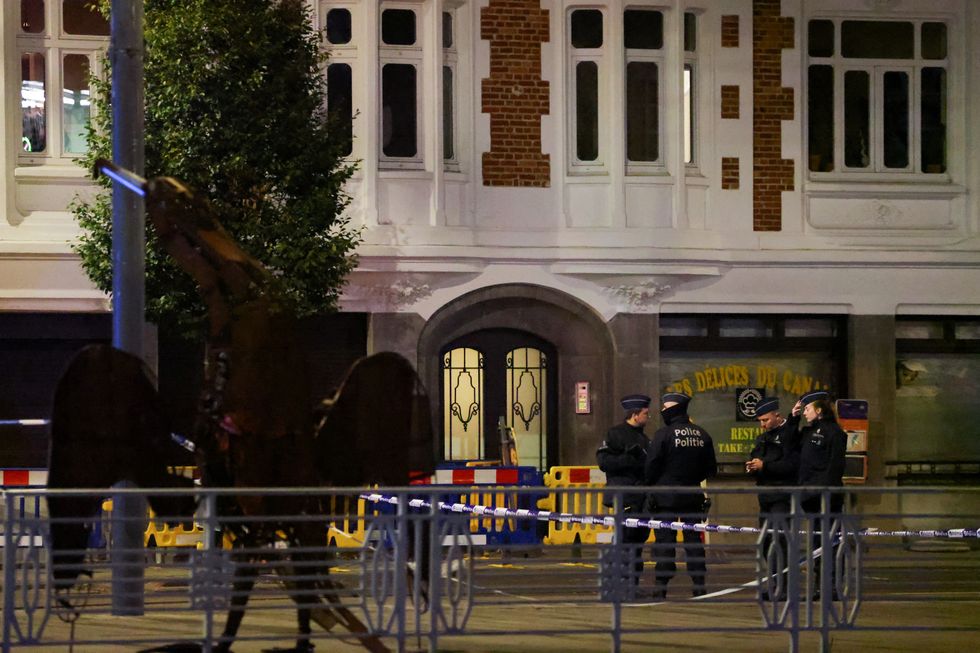 Belgian police secure the area after a shooting in Brussels