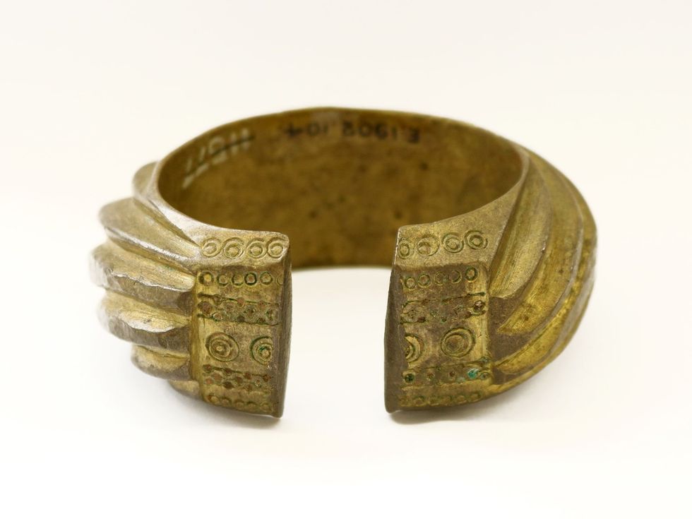 Benin Bronzes: \u200bA brass penannular bracelet decorated with heavy slanting bands