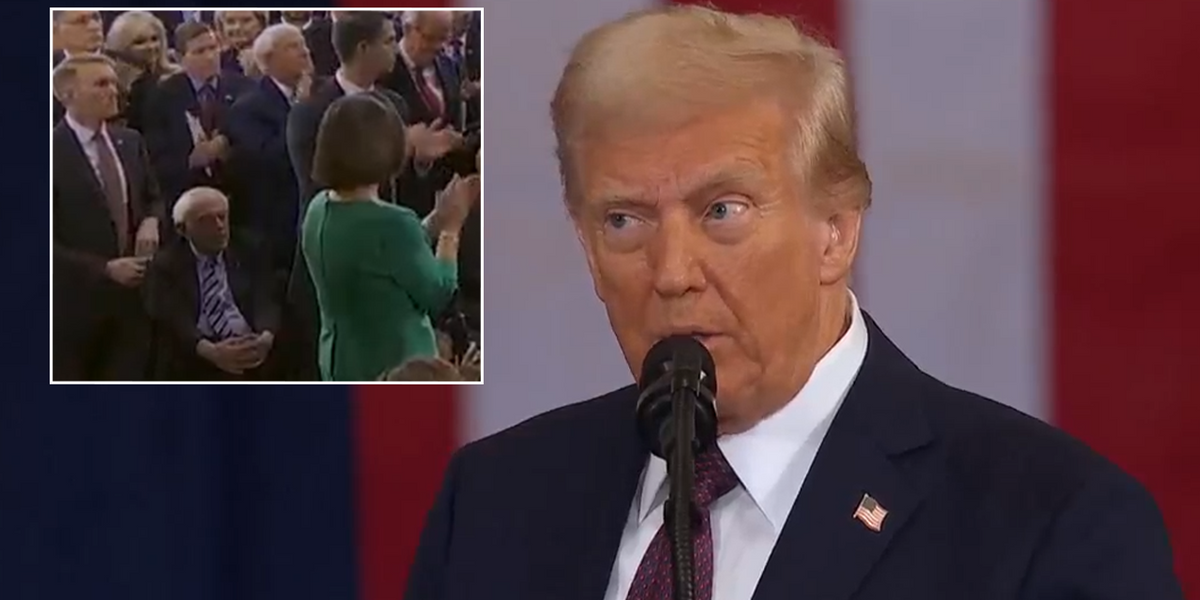 NextImg:Bernie Sanders stays sat during standing ovation as Trump makes ‘emergency’ announcement