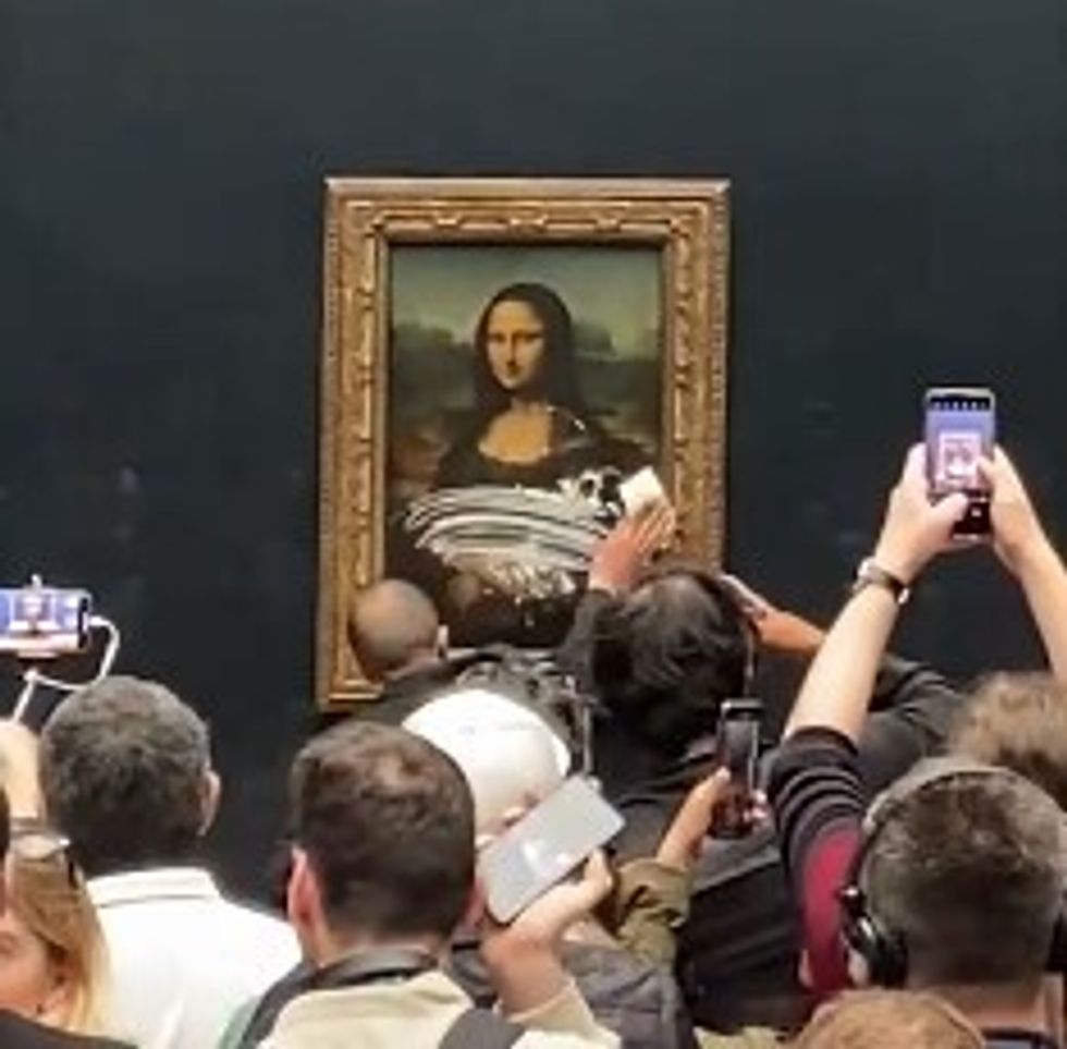 BEST QUALITY AVAILABLE Video grab dated 29/05/22 courtesy of Lukeee @lukeXC2002 of a staff member at the Louvre in Paris wiping cream of off protective glass covering Leonardo da Vinci's Mona Lisa painting after a man disguised as an elderly woman in a wheelchair threw a cake at it. Issue date: Monday May 30, 2022.
