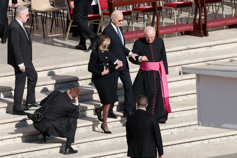 Biden helped down stairs