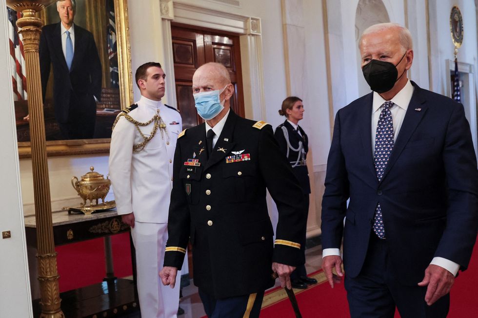 Biden walks next to Captain Larry Taylor