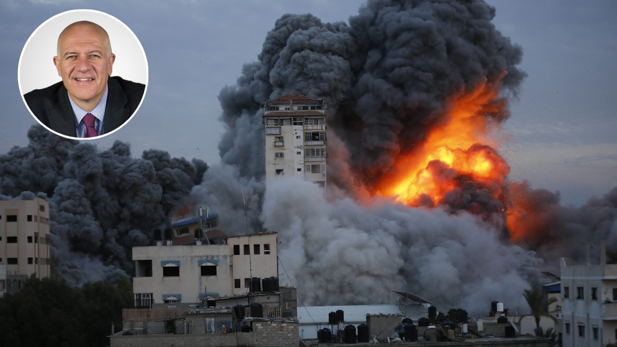 Bill Rammell and Smoke and flame rise after Israeli air forces targeting a shopping center in Gaza Strip