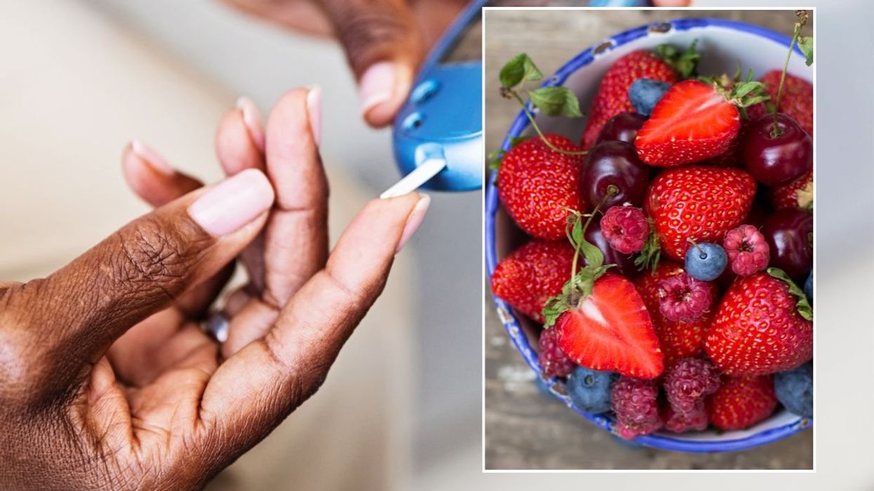 BLOOD GLUCOSE MONITOR AND BOWL OF BERRIES
