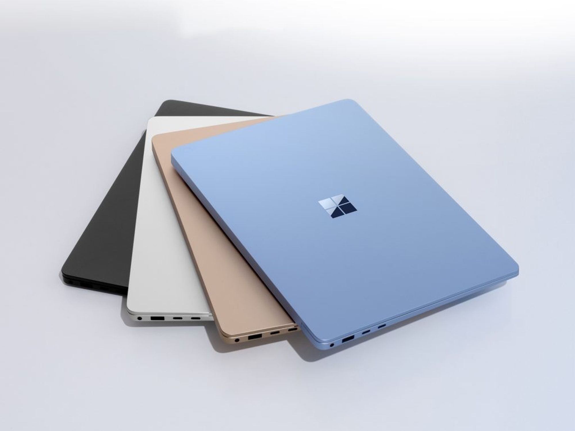 blue microsoft surface laptop sitting on a pile of other windows 11 laptops from microsoft
