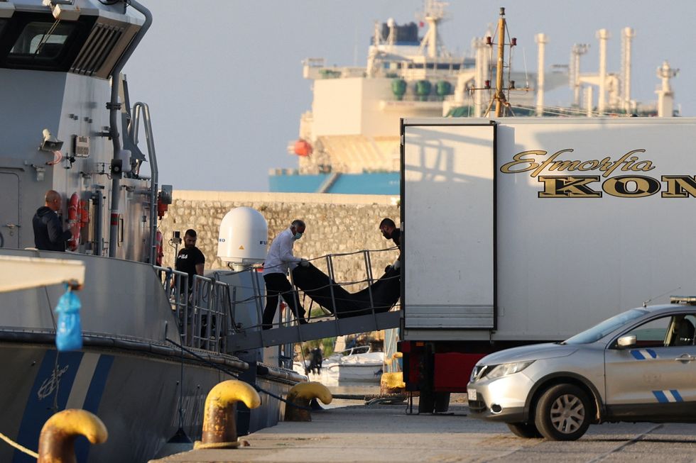 Body bags are unloaded at Kalamata