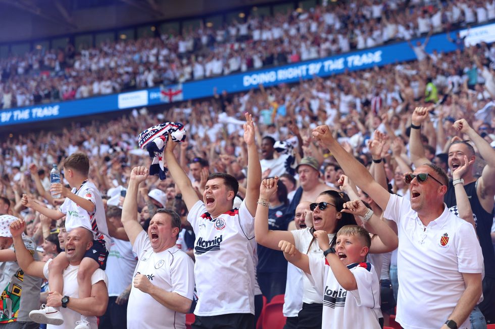 Bolton fans celebrate their side's victory over Stockport at Wembley