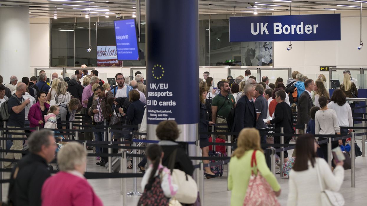 Border Force check the passports of passengers arriving at Gatwick Airport