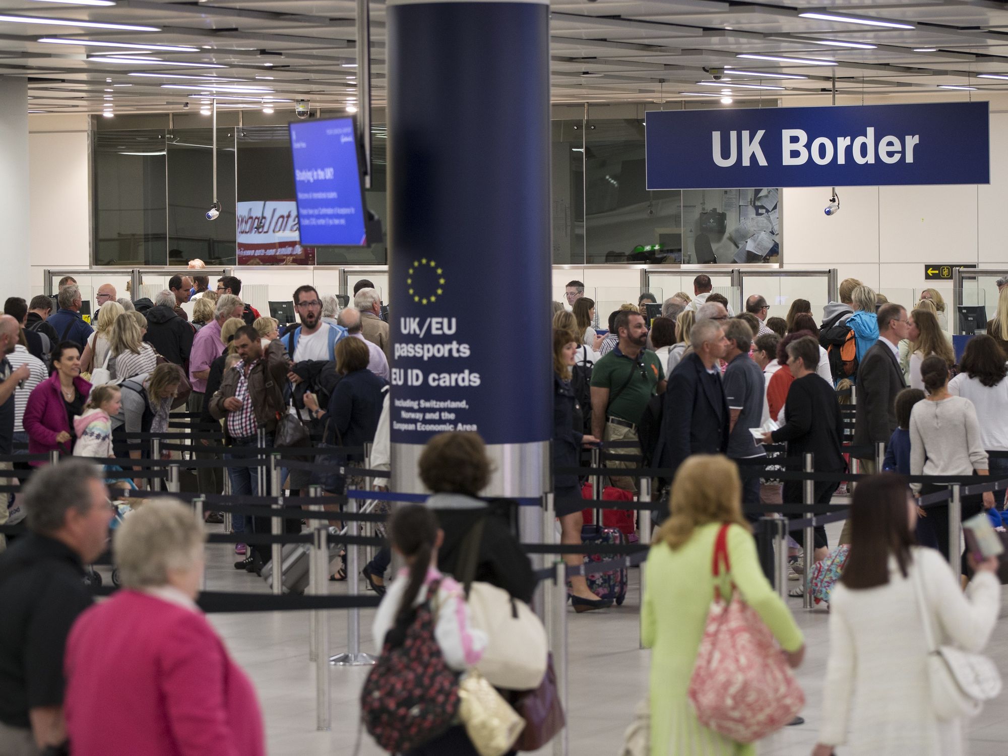 Border Force check the passports of passengers arriving at Gatwick Airport