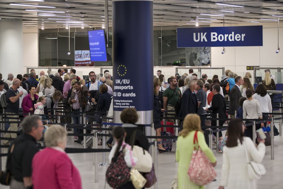 Border Force check the passports of passengers arriving at Gatwick Airport