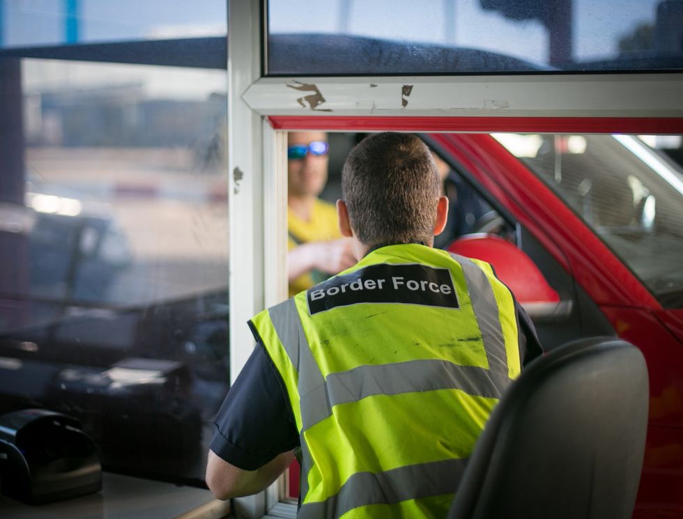 Border Force staff check passports of motorists arriving at the UK border after leaving a cross-channel ferry