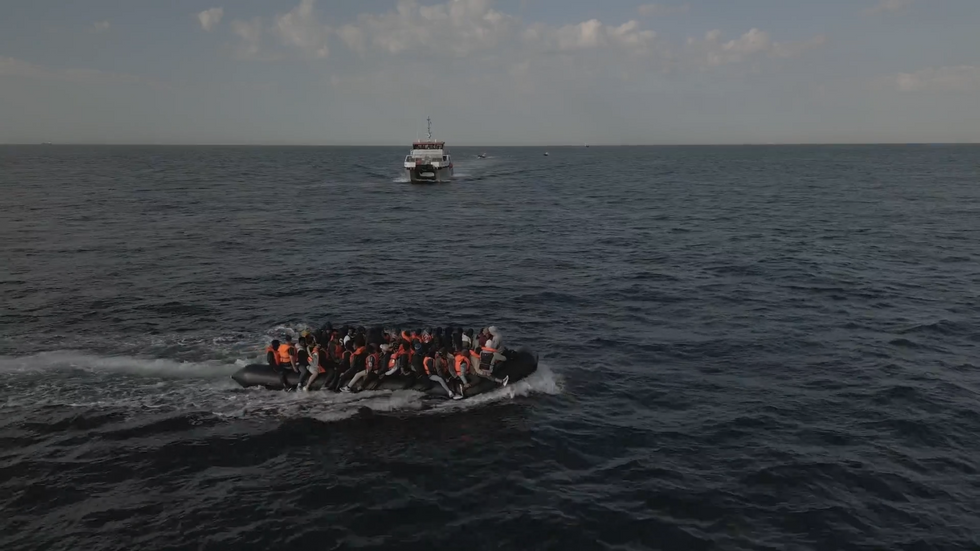Border force vessel approaches migrant boat